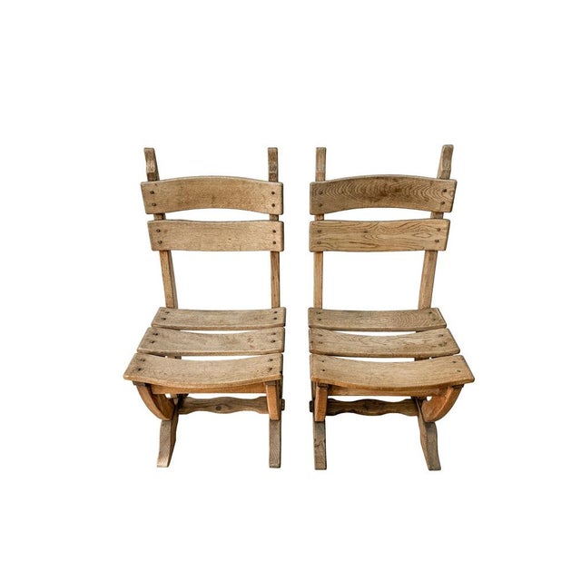 These robust lounge chairs are made of solid oak and are reminiscent of designs Pierre Chapo oder Charlotte Perriand and...