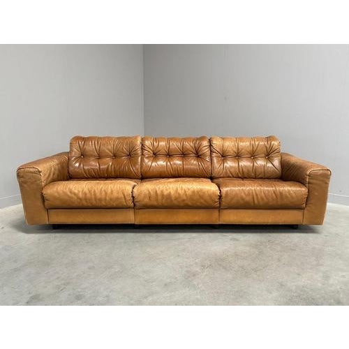 Remarks: Mid century lounge sofa by De Sede. Design by Robert Haussmann, Switzerland 1970s. Wooden frame with cognac...