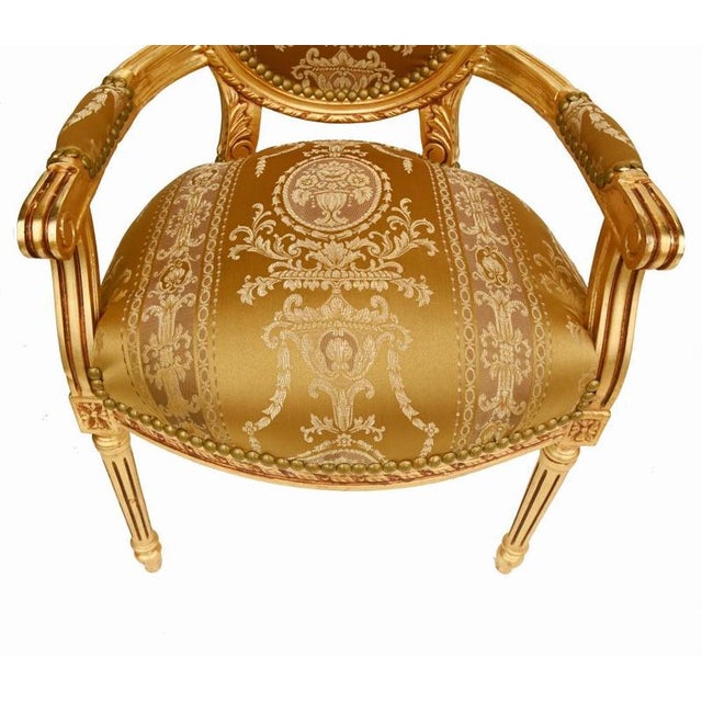 A superb pair of louis xvi style giltwood salon armchairs, elegantly designed with classic neoclassical proportions and...