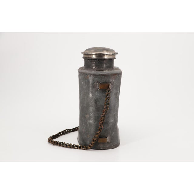 Circa: 19th Century. Origin: England. Material: Pewter with brass handles and brass chain. Item condition: Some dents,...