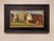 This oil on panel artwork captures a serene farm scene, highlighting a classic red barn and towering silos set against a...