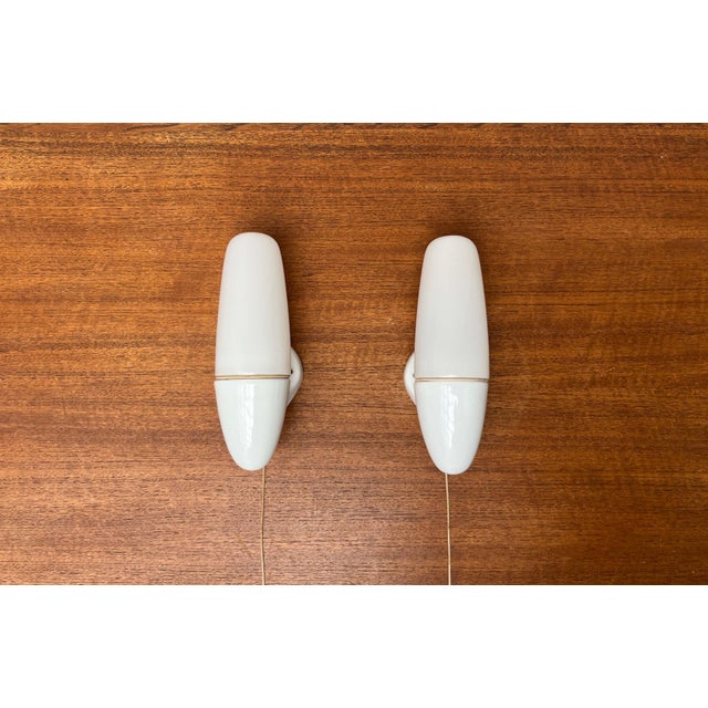 Set of two classic Lindner wall lamps designed by Wilhelm Wagenfeld in the 1950s. The 6065 is a functional, elegant, and...