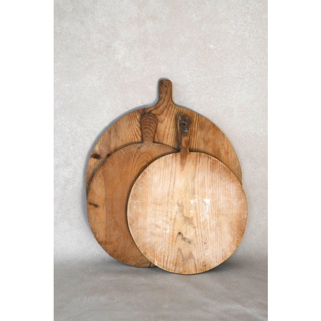 This early 20th century antique European breadboard is hand-carved from solid wood and worn beautifully with age. Perfect...