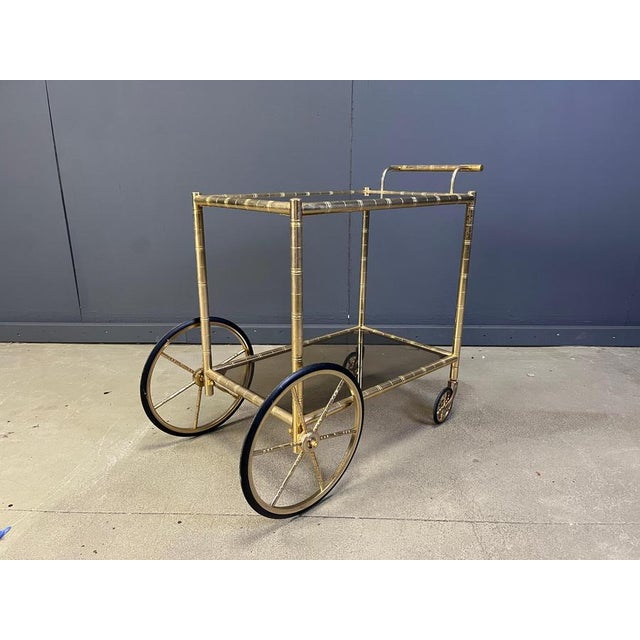 Elegant mid century faux bamboo brass serving trolley with smoked glass. Made by Orsenigo italy. 1970s- Italy Good...