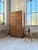 Antique and large 1950s oak drop-front cabinet. comprising 14 drop-front compartments topped with metal shell handles and...