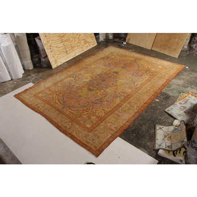 Hand knotted in wool originating from Turkey circa 1880-1899, this antique rug connotes a 19th-Century Oushak design with...
