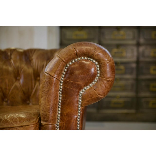 Two-seater Chesterfield leather sofa. An English icon born in the 19th century, the Chesterfield is recognizable by its...