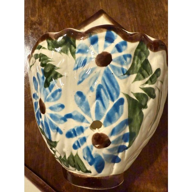 This collection features three distinct wall pockets, each designed to be mounted on a vertical surface. They are crafted...