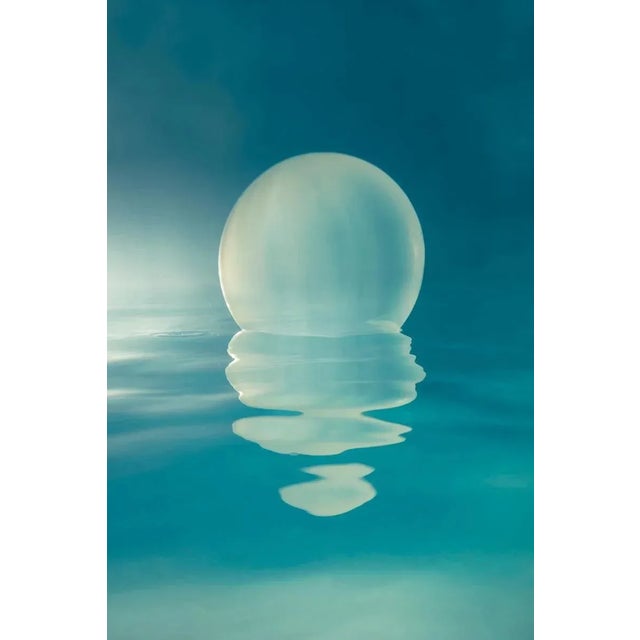 Lone is about centering and focus. I liked the paring of the orb in its perfect shape with its reflection melting into pieces