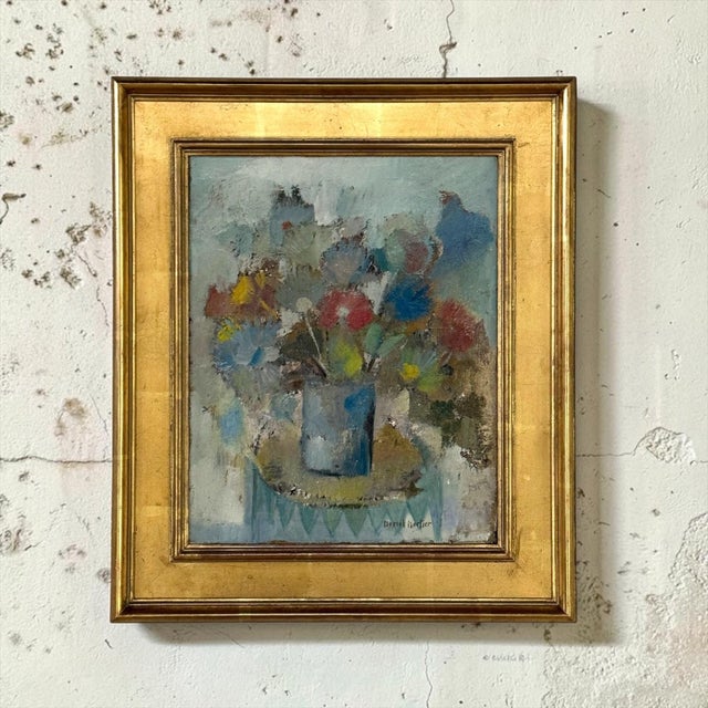A floral still life in oil on canvas by Belgian painter Marcel Mortier, in its original gold leaf frame chosen by the...