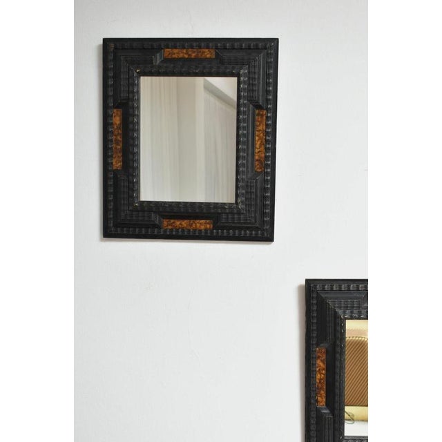 Pair of carved ebonised wood and trompe l'oeil turshell mirrors, XIXth c. Height: 48 cm - 18.9 in Length: 42 cm - 16.54 in...