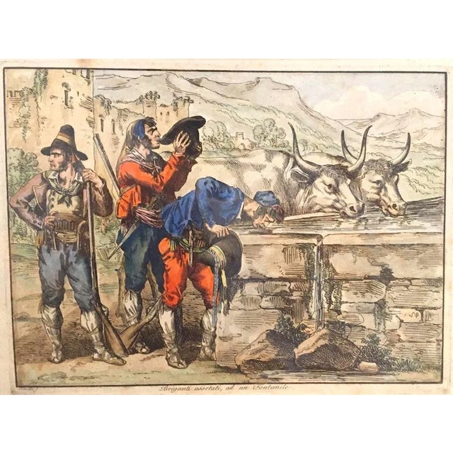 Briganti assetati is a beautiful artwork realized by Bartolomeo Pinelli in 1820. Etching and Watercolor technique. In Good...