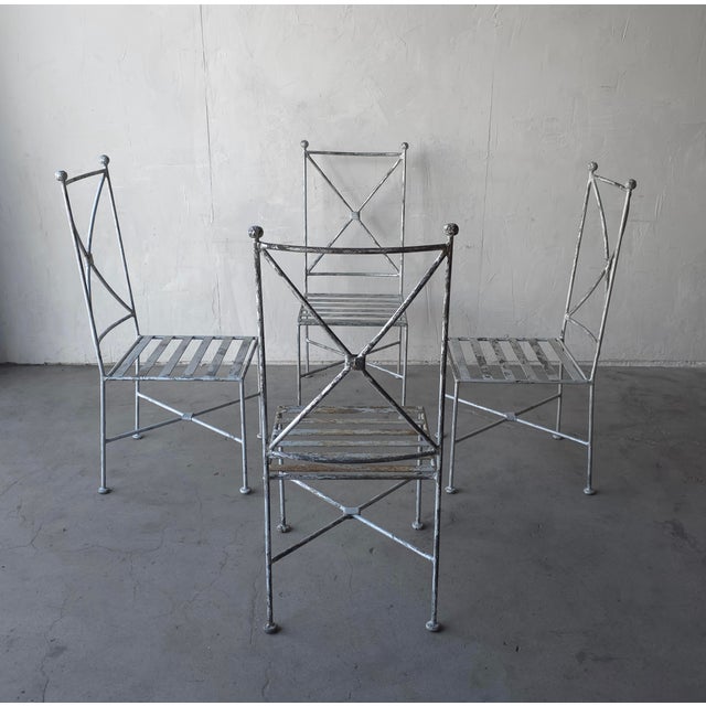 This is a great set of 4 vintage Iron garden chairs with sculptural X-form backs and a beautifully weathered finish. Their...