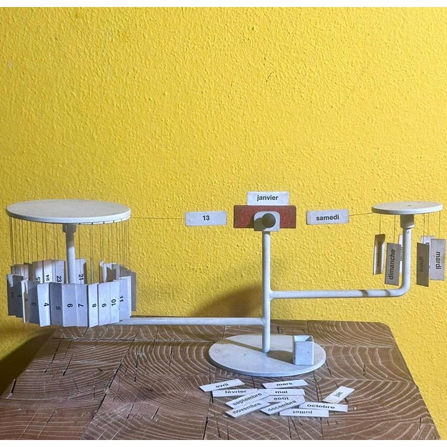 Designed in the late 1950s, this perpetual calendar translates time into a small mechanical landscape: suspended wires,...