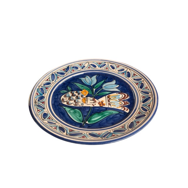 A vintage Mediterranean-style terracotta ceramic wall plate. Masterfully hand-painted, this decorative accent features a...