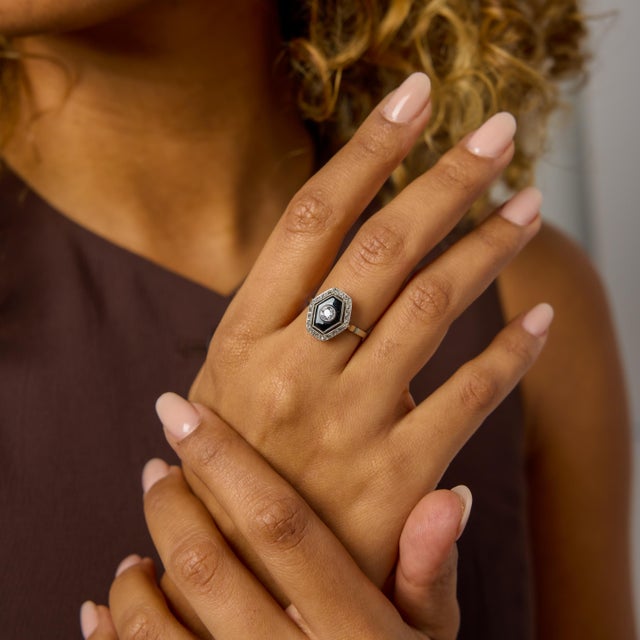 This Art Deco onyx and diamond ring is a compelling expression of contrast and geometry, hallmarks of the era’s most...