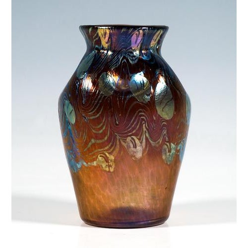 Mould blown, conically widening body on a flush round base, forming rounded shoulders, neck constriction with flared rim,...