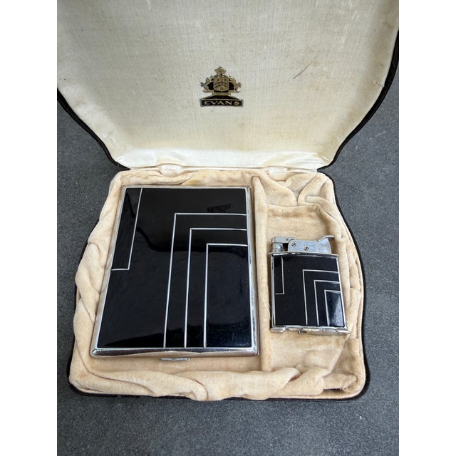 Art Deco black enamel with silvered chrome geometric design cigarette case and lighter manufactured by Evan, USA. The case...