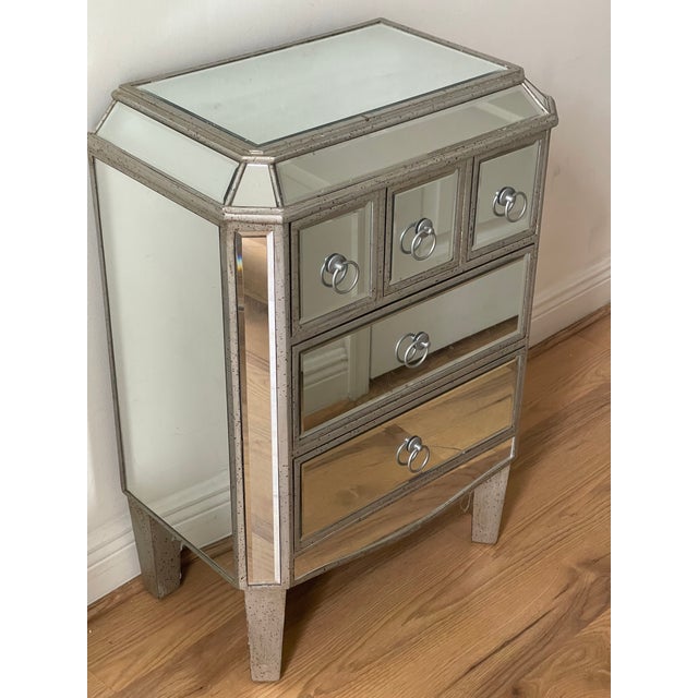 Cute small mirrored commode with three small drawers in the upper level, on tapered legs. In Hollywood Regency style....
