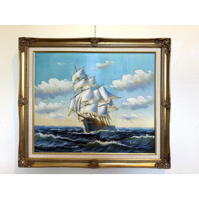 Beautiful vintage oil on canvas depicting a classic sailing ship navigating rolling ocean waves under a bright sky filled...