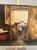 This classic rustic Early American farmhouse style still life oil painting on canvas depicts a scene of one peering out of...