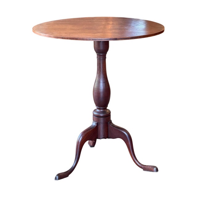 A well-proportioned oval tilt-top table on a turned baluster pedestal with a good warm patina. The top tilts on a brass...