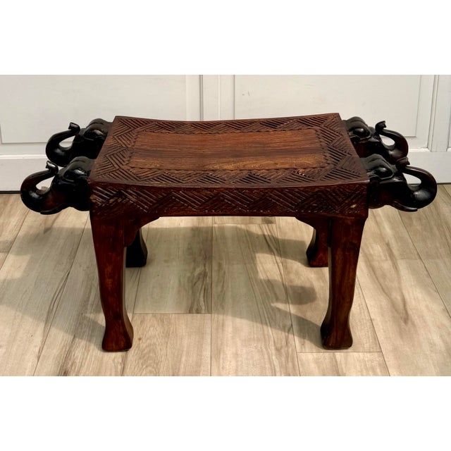 Here is a wonderfully sculptural vintage Indian bench, hand-carved from solid hardwood and featuring four dramatic...