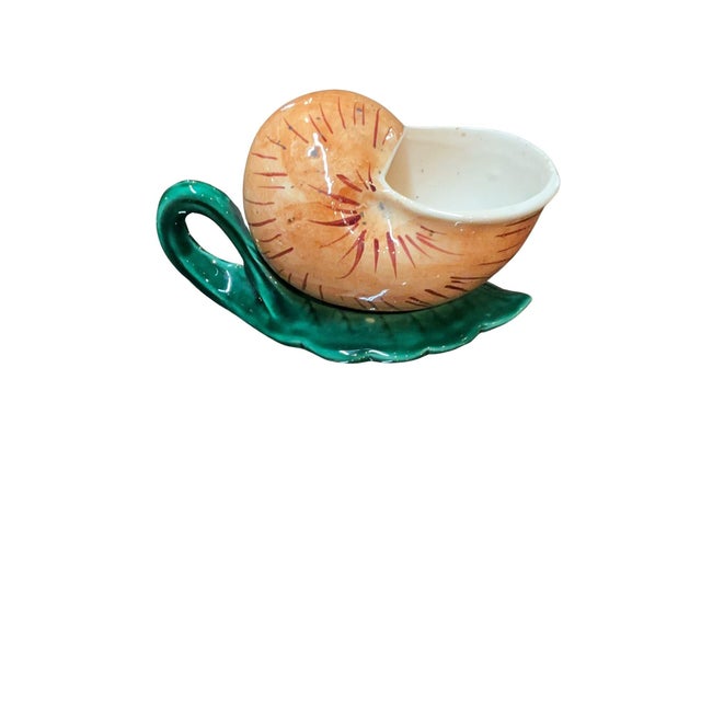 Beautiful barbotine majolica saucier in the shape of a snail. The shell is painted with an orange/yellow glaze and...
