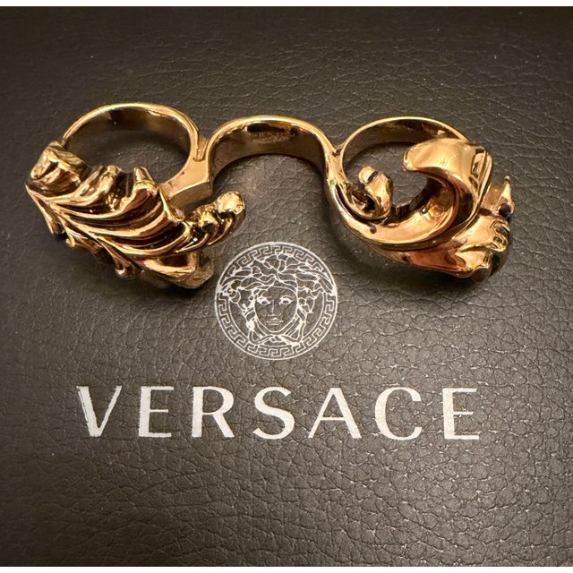 Retro Versace antiqued gold metal three-finger ring with Medusa logo and foliate detailing. Each ring is a different US...