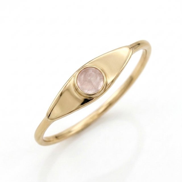 Soft romance meets sleek modern design. This delicate signet ring features a soft pink, 3mm round-cut Rose Quartz gemstone...