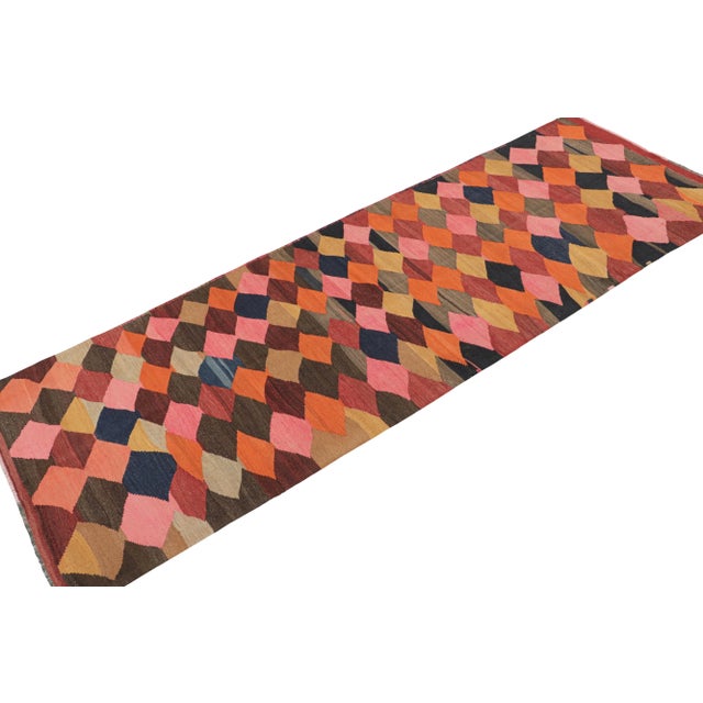 This vintage 4x10 Persian Kilim is believed to be a tribal runner of Karadagh—a mountainous region known for its craft....