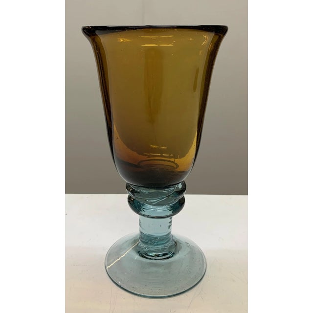 These are hand blown barware and unique pieces that have an amber hue for the body and a light blue color for the stem and...