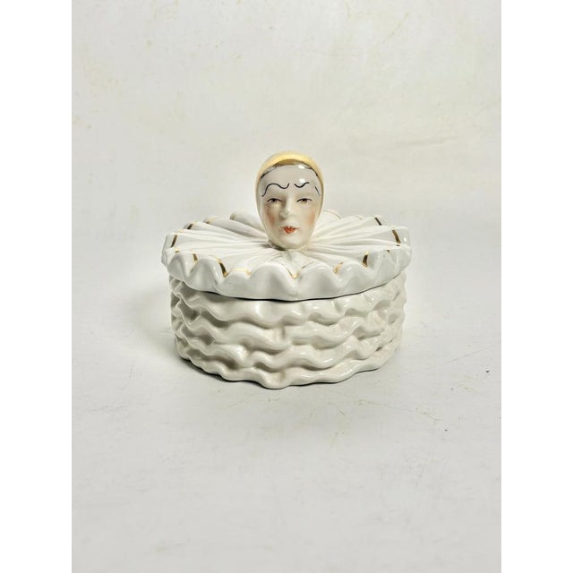 A decorative French porcelain box, dating from the 1970s, depicting a stylized Pierrot, an iconic figure in the world of...