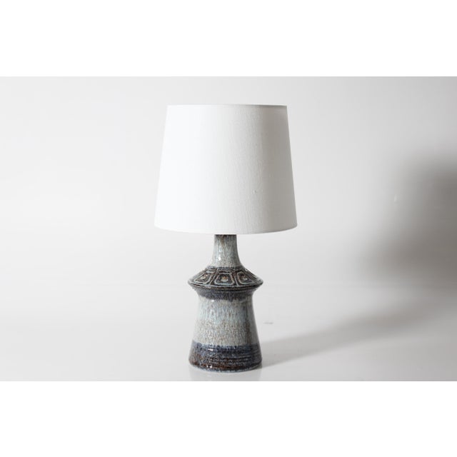 Mid-century Danish ceramic table lamp by Jette Hellerøe for the ceramic workshop Axella. Made circa 1970s. The base is...