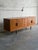 This minimalist storage piece features an elongated rectangular silhouette balanced beautifully on tapered legs. The front...