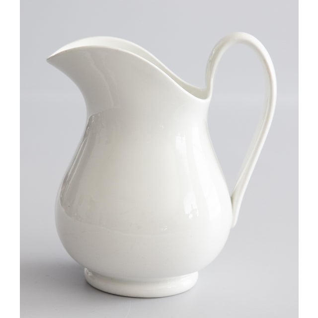 A superb antique Dutch white ironstone pitcher by Petrus Regout in Maastricht, Holland, circa 1890. Maker's mark on the...