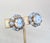 1950s round goldtone baby blue & clear givre round center with faceted bead surround clip earrings. Marked "CARNEGIE" on...