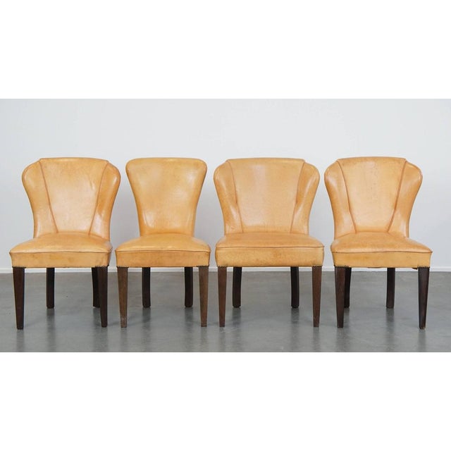 Special set of 4 comfortable honey-colored goatskin leather dining room chairs in good condition. A unique eye-catcher...