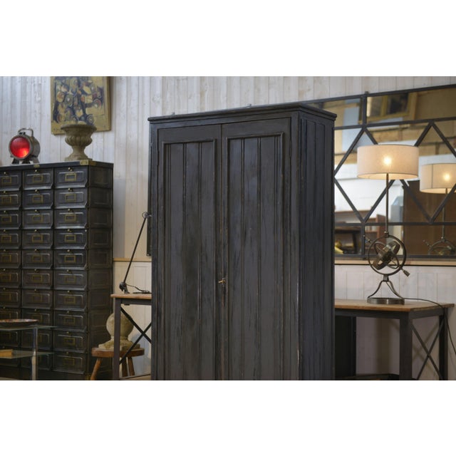 Tall wardrobe from the 1950s, with a beautiful anthracite patina, intentionally matte and deep. The simple two-door front...