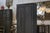 Tall wardrobe from the 1950s, with a beautiful anthracite patina, intentionally matte and deep. The simple two-door front...