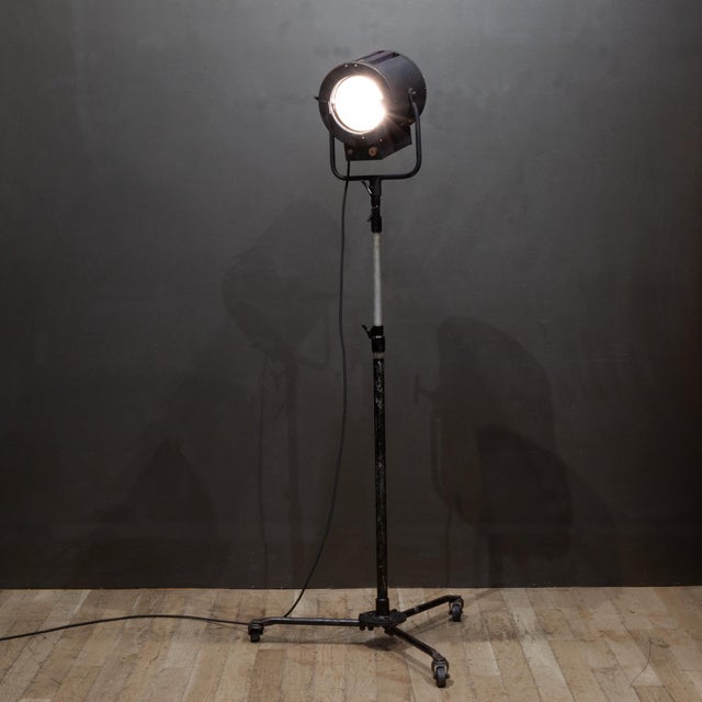 ABOUT This vintage Hollywood spotlight dates back to the mid-20th century film era, featuring a matte black industrial...