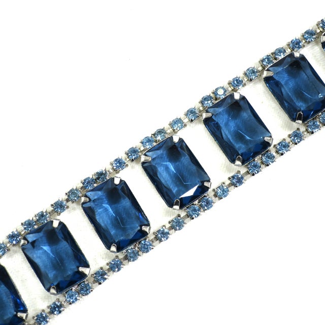 Vintage 1960s designer sapphire crystal & rhodium-plated bracelet. A series of large emerald-cut open-back sapphire...