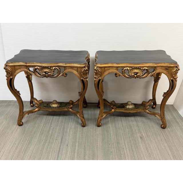 Design Plus Gallery presents a Pair of Antique Rococo Revival Side Tables. Each table has a shaped, black-painted top...