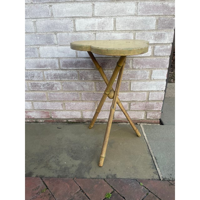 This darling rustic tripod side table has bamboo legs joined by a trefoil top and a wooden ball. This piece was painted...