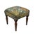 Meticulously handcrafted in the United Kingdom, this upholstered stool boasts classic studding and hand-polished solid...