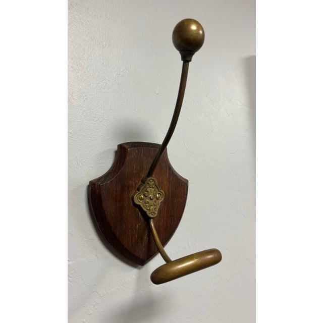 A handsome vintage wall-mounted coat and hat hook that turns a simple household necessity into a small moment of...