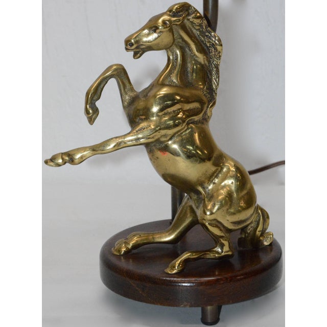 We are offering a vintage table lamp consisting of a round wooden base with a dark walnut stain. A polished, solid brass...