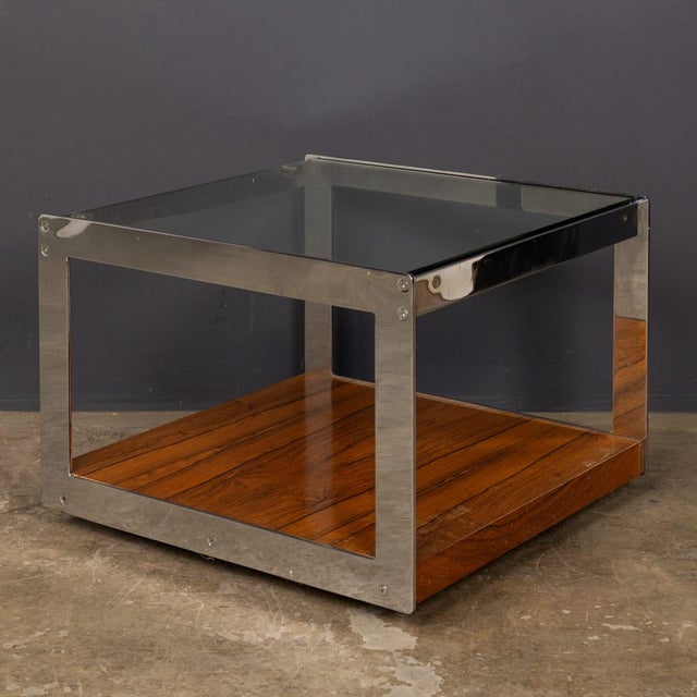 A vintage 20th Century stylish and versatile occasional table by Merrow Associates of Guildford, featuring a sleek chrome...