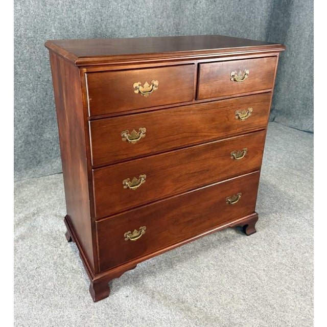 This vintage five drawer solid cherry dresser chest features a warm, rich finish with clean traditional lines and gently...