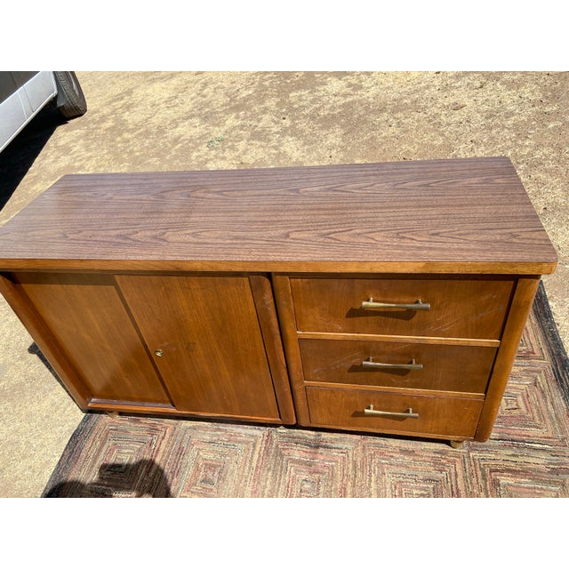 The Jofco Furniture Vintage Mid Century Modern Walnut Credenza is a stylish and timeless piece of furniture that embodies...